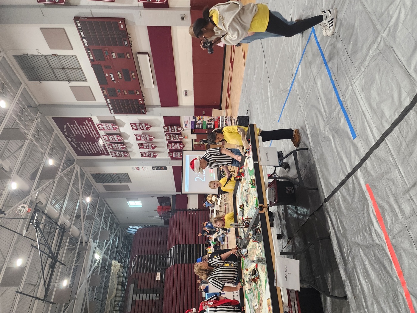Coach and student at the FIRST banner